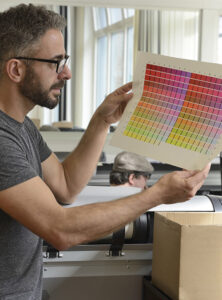 printer man looking at the colorful print