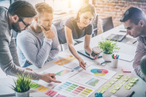 one woman and three men in a meeting